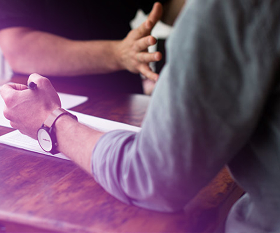 Image of two people filling out forms in an office - representing how Accountivity and the Mier brands can help employers